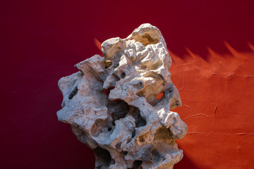 Red wall with unique stone in the forbidden city. Chinese traditional symbols. Minimal background.