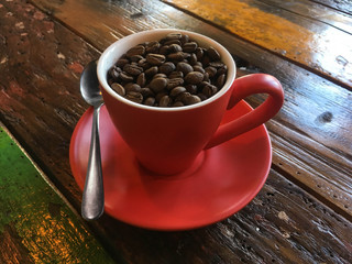 Coffee cup full of coffee beans.