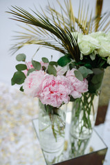 Pink peonies and roses in a wedding decor.