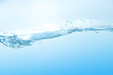 Water splash. Aqua flowing in waves and creating bubbles. Drops on the water surface feel fresh and clean. isolated on white background.