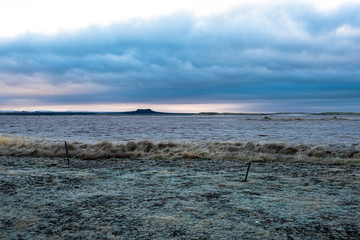 A plain in western Iceland appears frozen at first light of day