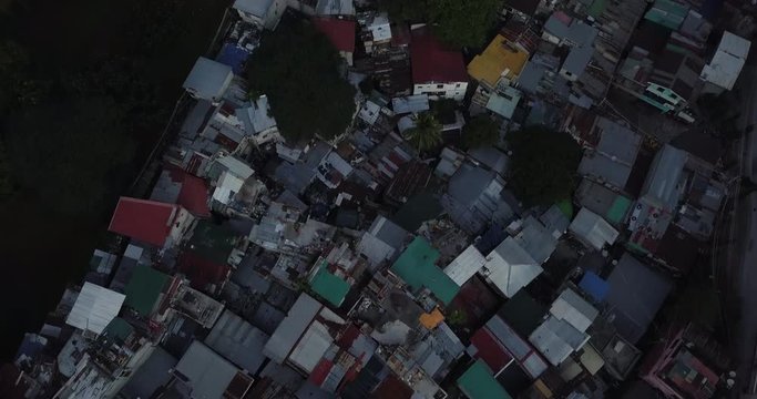 Contrast aerial flight of poor housing area, Tilt up to reveal developed business district. Urban view. Drone, 4K. 

Frame rate: 23.98
Video Codec: ProRes 422HQ
BGC, Taguig, Manila, Philippines
