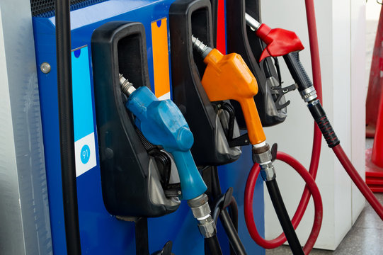 three nuzzle blue orange red pump in gas stration