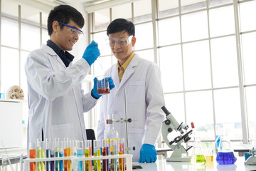 Science, Chemistry, Technology, Biology and Laboratory concept - Asian senior scientist is looking...
