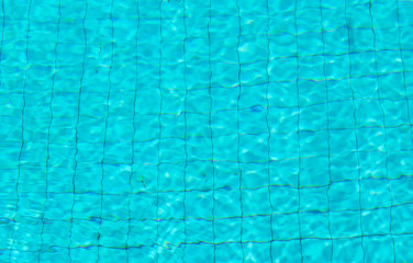 Blue Water and tile sun Reflections on swimming pool  background Texture