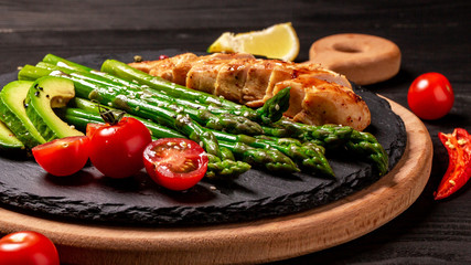 Balanced healthy food grilled chicken and avocado with asparagus. Keto paleo diet recipe
