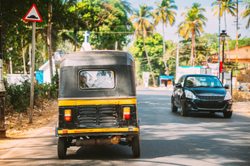 Goa, India. Auto Rickshaw Or Tuk-tuk Moving On Street. Back View