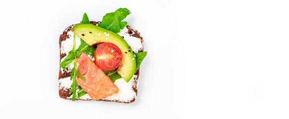 sandwich with salmon arugula, ricotta cheese and avocado on a white background. Top view. Long banner format. space for text