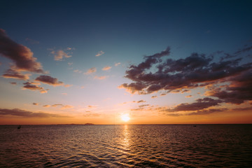 Fototapeta na wymiar Midsummer beautiful sunset and sunrise sky reflection on sea ocean beach wave.