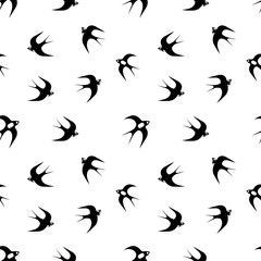 Hand-drawn black vector seamless pattern illustration of group of swallows or martlets are flying on a white background