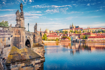 Beautiful morning view of Charles Bridge, Prague Castle and St. Vitus cathedral on Vltava river. Stunning summer cityscape of Prague, Czech Republic, Europe. Traveling concept background.