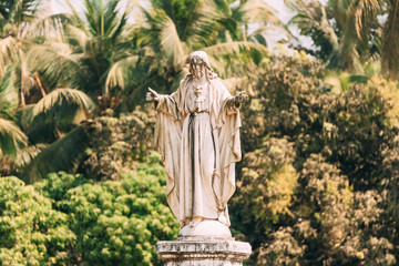 Old Goa, India. Cathedral Of St. Paul And Statue Of Jesus In Sunny Day