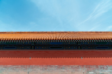 Chinese traditional red wall with blue sky. Minimal background.