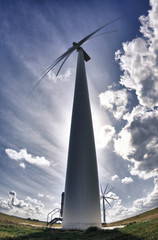 Wind turbines in field with sky and clouds 