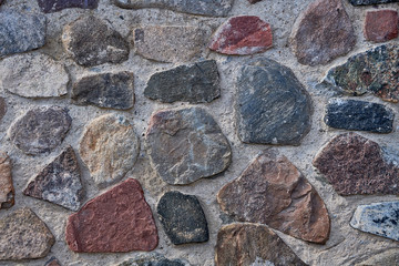 Background masonry made of natural stone. Cement and cobblestones.