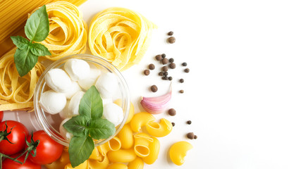 food on a white background pasta, spaghetti, garlic, mozzarella, tomatoes, pepper. Vegan salad.