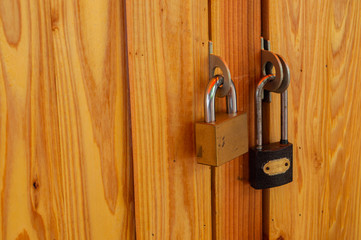 gold and black two key lock wood door