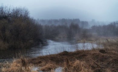 A river on a foggy morning at sunrise