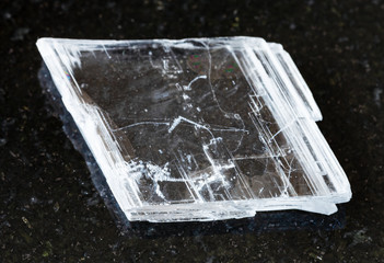 closeup of sample of natural mineral from geological collection - rough Gypsum rock on black...