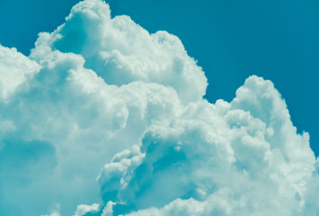 Beautiful puffy clouds against pastel blue skies. 
