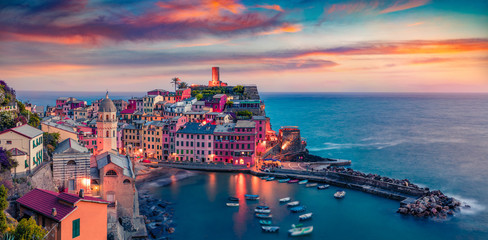 Panoramic evening cityscape of Vernazza port, Cinque Terre region. Unbelievable summer sunset on Liguria, Italy, Europe. Superb seascape of Mediterranean sea. Traveling concept background.