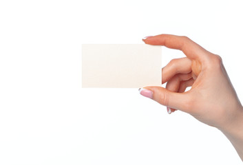 Obraz premium Beautiful female hand holding white business card on white background