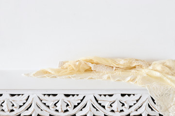 background Image of vintage table and lace fabric in front of white wall. ready for product display