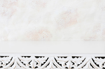 background Image of vintage table in front of white oriental decorative wall. ready for product display