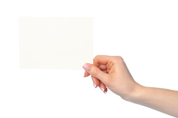 Fototapeta premium Woman's hand holding blank white sheet of paper isolated on white