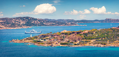 Panoramic summer view of Palau town, Province of Olbia-Tempio, Italy, Europe. Sunny morning view of Sardinia island. Picturesque seascape om Mediterranean sea. Traveling concept background.