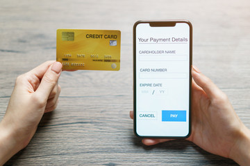 Mobile payments. hands using smartphone and credit card for online shopping.