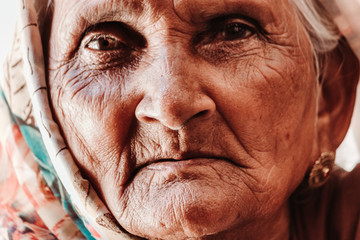 Closeup shot of the eyes of an old woman staring at the camera	
