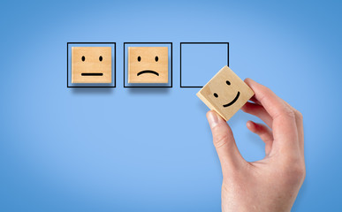 Hand folds up rating with happy icon, concept of customer satisfaction survey