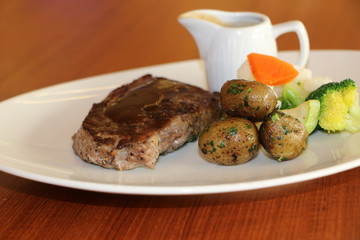 GRILLED BEEF STEAK, HERB ROASTED BABY POTATO, SAUTÉED VEGETABLES, PEPPER CREAM SAUCE
