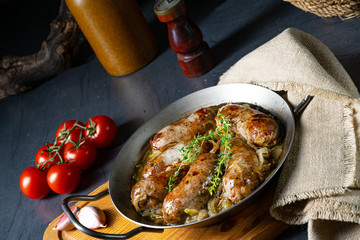 Homemade white sausage fried with onion and herbs
