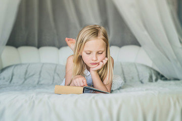 Distance education. School girl reading book