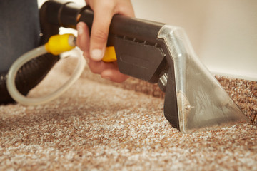 Detail of cleaning deeply carpet with wet and dry cleaning machine