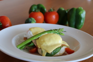 Eggs benedicts, Poached eggs on brioche bun,
turkey bacon, asparagus and
top with hollandaise sauce
