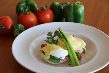 Eggs benedicts, Poached eggs on brioche bun,
turkey bacon, asparagus and
top with hollandaise sauce