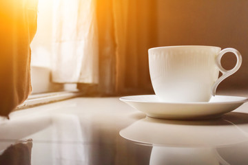Smooth Focus and soft Focus,Hot coffee in a cup of coffee placed on the bedroom floor by the window in the morning was placed to prepare for drinking coffee before work.