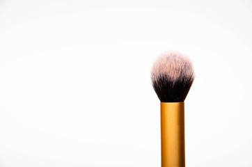 Large fluffy makeup brush with gold pen and black edge. The brush stands vertically in the middle and side of the full size and edge of the brush