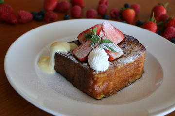 French Toast, Baked brioche layered with whipped cream,
strawberry, nuts and cream anglaise 