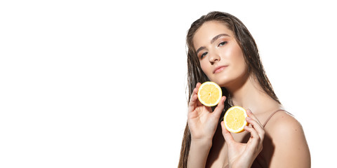 Obraz na płótnie Canvas Close up of beautiful young woman with lemon slices on white background. Concept of cosmetics, makeup, natural and eco treatment, skin care. Shiny and healthy skin, healthcare. Flyer with copyspace.