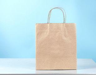 Paper bag on table blue background.Shopping and business.