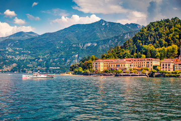 Fototapeta na wymiar Colorful summer cityscape of Bellagio town, view from ferry boat. Tourist boat on Como lake, Italy, Europe. Traveling concept background.