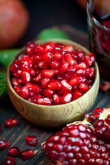 Ripe pomegranate fruit on a old black wooden vintage background. Selective focus.