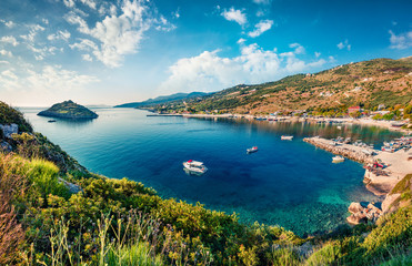 Sunny morning view of Agios Nikolaos, small port on the island of Zakynthos, Greece, Europe. Beautiful summer seascape of Ionian sea. Traveling concept background.