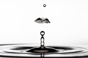 Collision of two water droplets hitting the surface