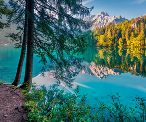 Calm morning view of Fusine lake. Fantastic summer scene of Julian Alps with Mangart peak on...