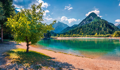 Sunny summer dayon Jasna lake. Stunning summer scene of Julian Alps, Gozd Martuljek location, Slovenia, Europe. Bright landscape of Triglav National Park.